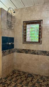 a bathroom with a shower with a window at Rustic AC Oasis on Ometepe Island in Santa Cruz +16 photos
