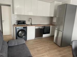 a kitchen with a stainless steel refrigerator and a dishwasher at El Rincón del Mirador in Carboneras de Guadazaón