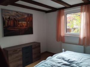 a bedroom with a bed and a window at Ferienwohnung Wechterswinkel in Bastheim