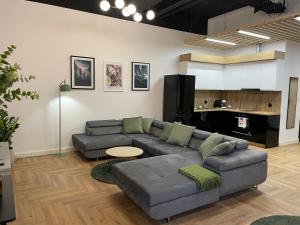 a living room with a couch and a table at Aleja 12 in Częstochowa
