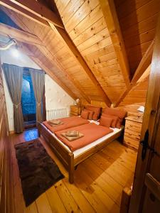 a bedroom with a bed in a wooden room at Chata Melissa in Námestovo