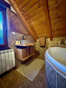 a bathroom with a tub and a sink at Chata Melissa in Námestovo +54 photos