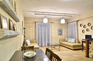 a living room with a couch and a table at Niriides Luxury Apartments in Syvota