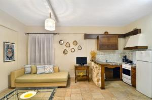 a living room with a couch and a kitchen at Niriides Luxury Apartments in Syvota