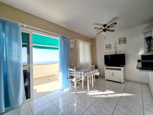A television and/or entertainment centre at Los Gigantes Amazing Sea view WiFi Pool Parking
