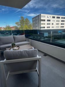 a balcony with couches and a table on a building at Apartman Ingrid in Zaprešić