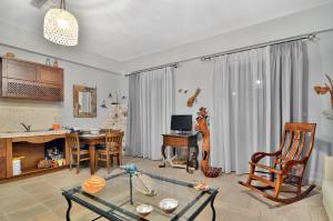 a living room with a table and a dining room at Niriides Luxury Apartments in Syvota