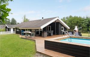 a backyard with a pool and a house at Lovely Home In Saltum With Kitchen in Saltum +18 photos