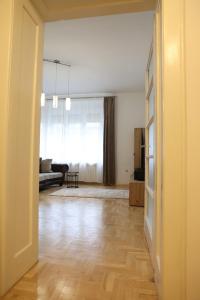an empty living room with a couch and a table at DM apartman in Osijek