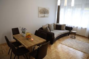 a living room with a couch and a table at DM apartman in Osijek