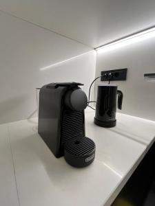 a kitchen counter with a toaster and a coffee maker at Apartman Ingrid in Zaprešić