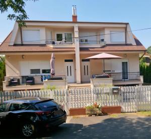 a black car parked in front of a house at Béri Apartman in Siófok +5 photos