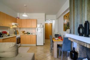 a kitchen with a table and a white refrigerator at Premium Athenian District Urban 1 bedroom flat C in Athens