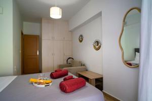 a room with a table with red pillows on it at Premium Athenian District Urban 1 bedroom flat C in Athens