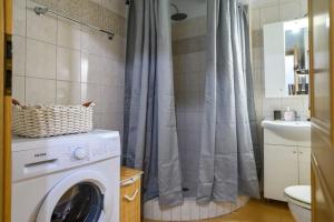 a washing machine in a bathroom with a shower at Premium Athenian District Urban 1 bedroom flat C in Athens +14 photos