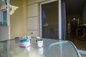 a glass table with cups on top of it at Premium Athenian District Urban 1 bedroom Flat D in Athens +9 photos