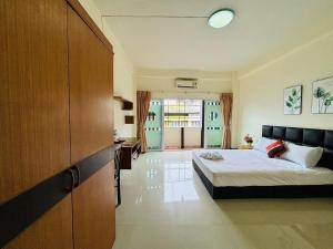 Una habitación de hotel con una cama y una cocina. en SERISIAM Apartments, en Hat Yai