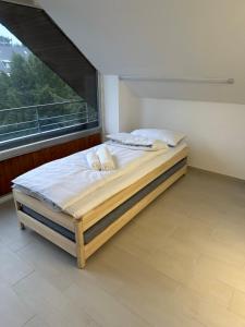 a bed in a room with a large window at Apartment-Checkin-Düsseldorf in Düsseldorf