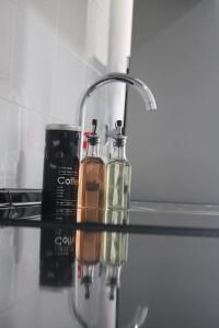 a glass counter top with two bottles on it at Apartment in Semeador 2 in Portalegre +25 photos