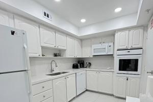 a white kitchen with white cabinets and white appliances at THE TIDES 1bedroom apt 15th floor WE ARE ON THE BEACH! in Hollywood