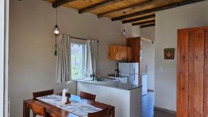 a kitchen with a table and a counter top at Casas 7 Cabritas in Tafí del Valle