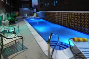 a large swimming pool on a building with two chairs at Courtyard by Marriott San Antonio Riverwalk in San Antonio