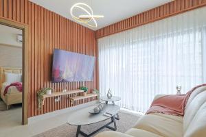 un salon avec un canapé et une grande fenêtre dans l'établissement Charming City Center Apt, Pool, à Saint-Domingue