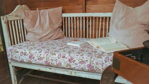 a bed with two pillows and a book on it at La Serra Sognante, terratetto con giardino privato tra Firenze e Fiesole in Florence