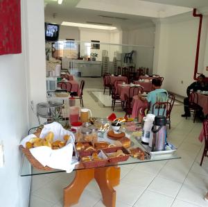 a table with a bunch of pastries on it at Hotel Sol e Mar in Vitória +7 photos