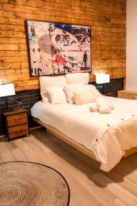 a bedroom with a large bed with wooden walls at Les Villas Saint-Roch in Quebec City