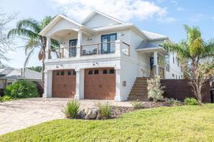 a large white house with a garage at 4BD 3BR Pool Paradise 1 mile from Beach & Downtown in Saint Augustine