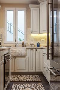 a kitchen with white cabinets and a sink at Villa Vendelina in Podgora