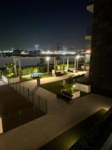 a view of a courtyard at night with lights at The Perfect Couples Nest in Dubai