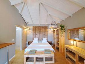 a bedroom with a large bed in a room at EDEN FOREST VILLA in Pointe-Noire +35 photos
