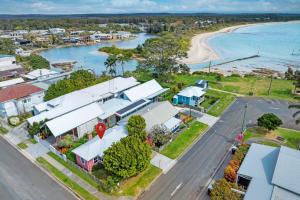 an aerial view of a coastal town with a beach at Atlantis retro beachside couples retreat in Currarong
