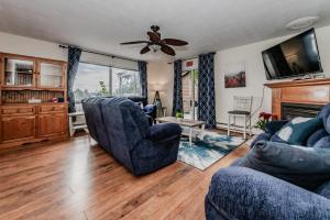 a living room with two chairs and a ceiling fan at Blue Moon Waterfront W Hot Tub in Wiarton