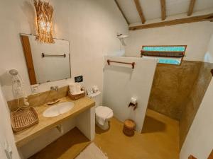a bathroom with a sink and a mirror at Villa Prana Caraíva in Caraíva
