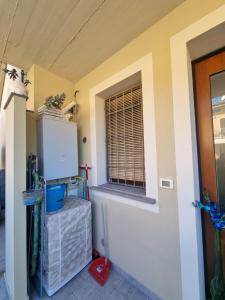 a room with a window and a refrigerator at A casa di Pablo in Collodi +22 photos