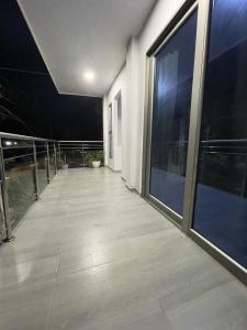 an empty hallway of a building with large windows at HOTEL HOUSE San Antero Córdoba in San Antero