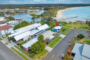 an aerial view of a coastal town with a beach at Aurora quintessential beachfront couples getaway in Currarong