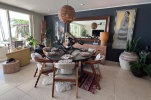 a dining room with a table and chairs and a mirror at BEACH GETAWAY! Luxury Beachfront Condo in Punta de Mita! in Punta Mita