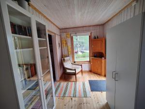 a living room with a chair and a window at 5 person holiday home in KARLSKOGA in Karlskoga +28 photos