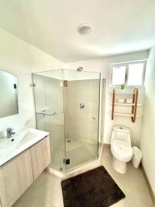 a bathroom with a shower and a toilet and a sink at Viva Jaco 9-05 in Jacó