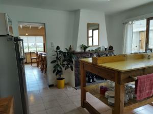 a kitchen with a table and a dining room at Hostel Yatel in El Calafate +42 photos