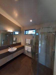 a bathroom with a sink and a shower at Executive Stay Tongariro in National Park +10 photos