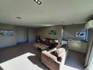a living room with a couch and a table at Executive Stay Tongariro in National Park