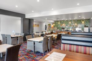 a restaurant with tables and chairs and a counter at 40 on Marshall Boutique Hotel in Goondiwindi