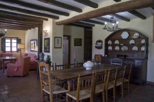 sala de estar con mesa de madera y sillas en Molino El Vinculo, en Zahara de la Sierra