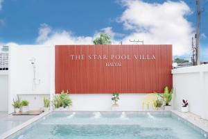 a sign on the side of a building with a swimming pool at The Star Pool Villa Hatyai in Hat Yai