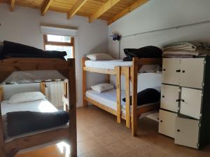 a room with four bunk beds in a house at Hostel Yatel in El Calafate